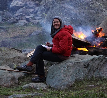 Photo of Jocelyn and other travelling companion in front of misty mountains and a large lake